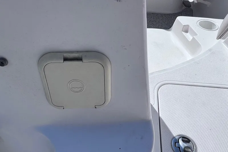 Slide: The Image of 2005 Hurricane FunDeck GS 202 OB boat interior with storage compartment and textured flooring. - 28