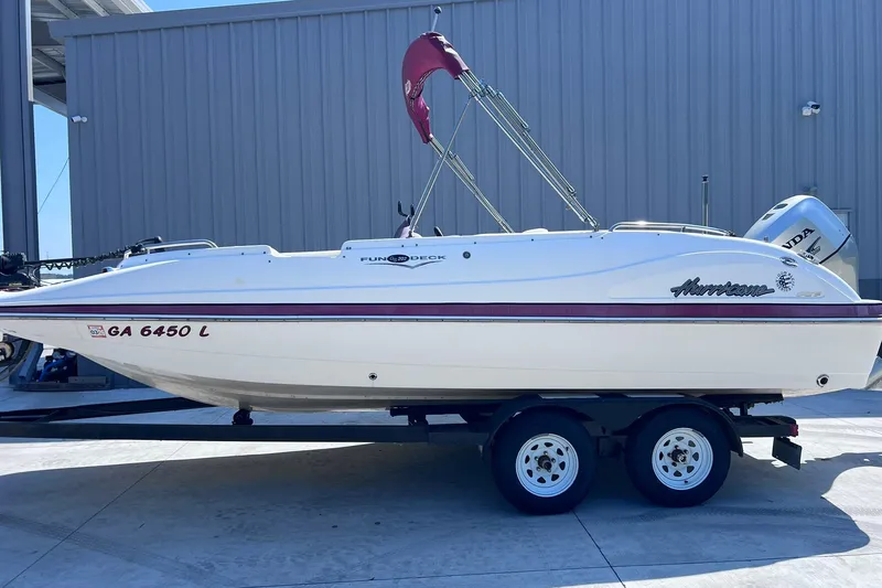 Slide: The Image of 2005 Hurricane FunDeck GS 202 OB boat on trailer, parked outdoors. - 39