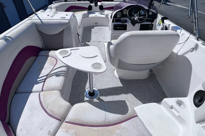 Slide: The Image of 2005 Hurricane FunDeck GS 202 OB interior with seating, table, and steering console. - 29