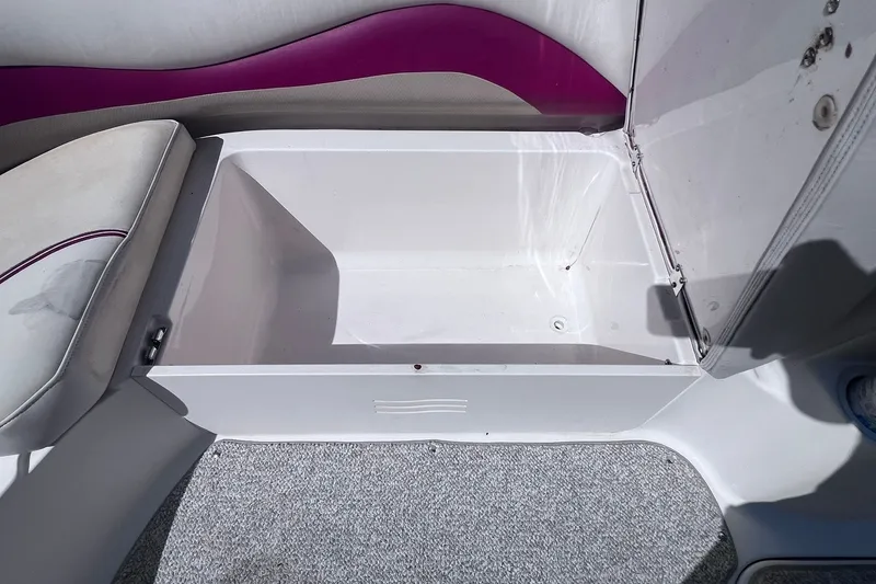 Slide: The Image of Storage compartment in a 2005 Hurricane FunDeck GS 202 OB boat, featuring white and purple interior. - 16