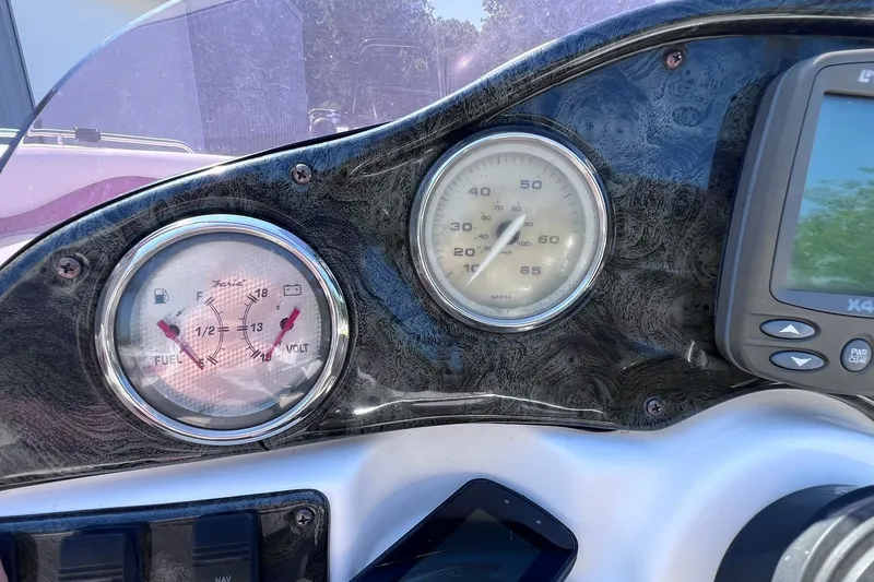 Slide: The Image of Dashboard of a 2005 Hurricane FunDeck GS 202 OB boat with gauges and controls. - 31