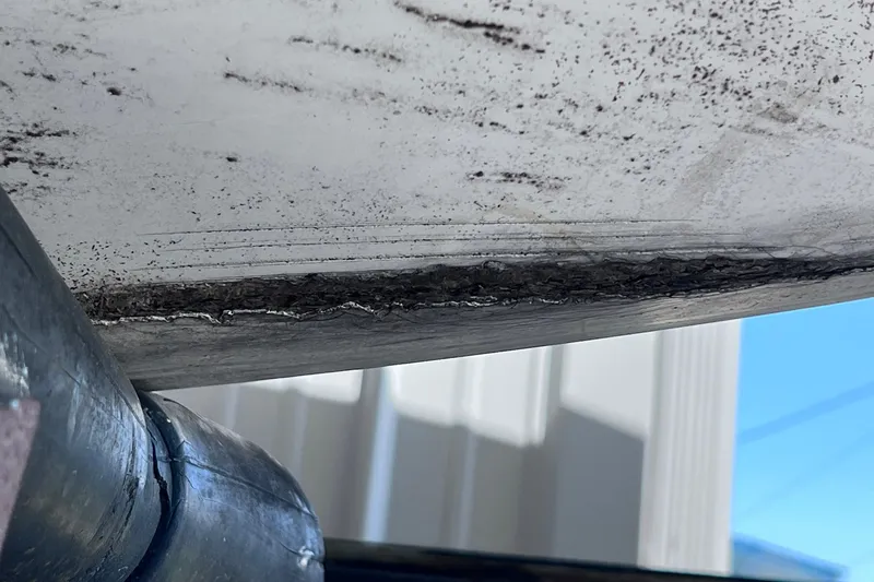 Slide: The Image of Close-up of a 2005 Hurricane FunDeck GS 202 OB hull with visible wear and damage. - 46