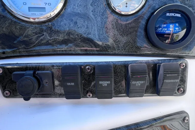 Slide: The Image of Control panel of a 2005 Hurricane FunDeck GS 202 OB boat with switches and gauges. - 33