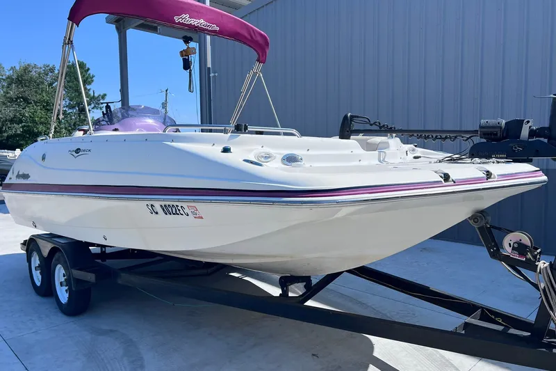 Slide: The Image of 2005 Hurricane FunDeck GS 202 OB boat on trailer, featuring maroon canopy and sleek design. - 3