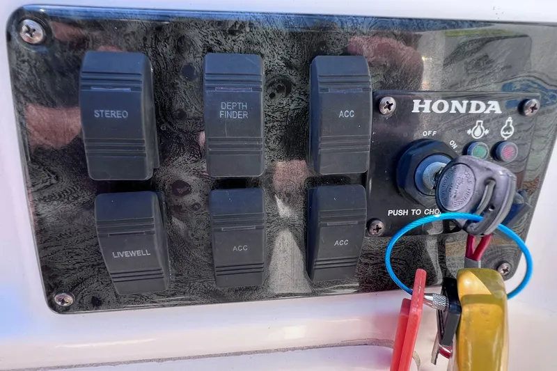 Slide: The Image of Control panel of a 2005 Hurricane FunDeck GS 202 OB boat with switches and ignition key. - 34