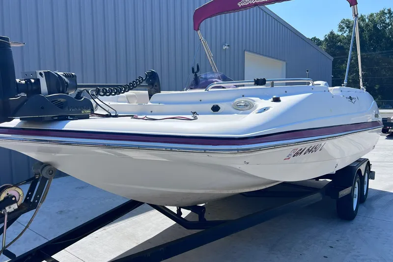 Slide: The Image of 2005 Hurricane FunDeck GS 202 OB boat on trailer, parked outside a warehouse. - 38