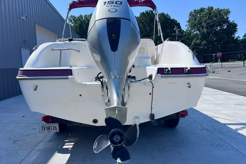 Slide: The Image of 2005 Hurricane FunDeck GS 202 OB boat with outboard motor, parked outdoors. - 5