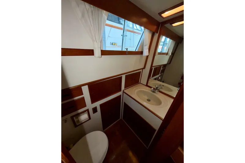 Slide: The Image of Bathroom interior of 1988 Grand Banks 42 Classic yacht, featuring sink, mirror, and window. - 62