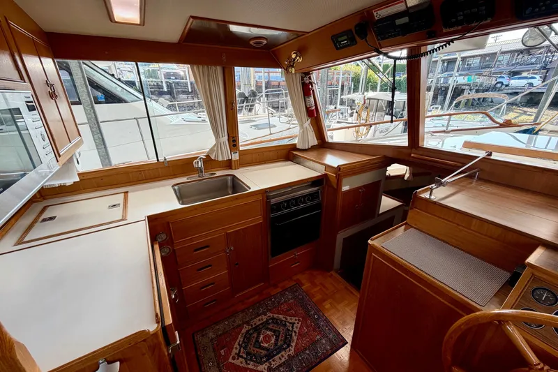 Slide: The Image of Interior of 1988 Grand Banks 42 Classic yacht with wooden cabinetry and modern appliances. - 38