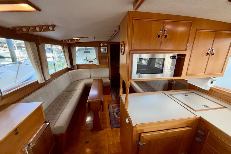 Slide: The Image of Interior of 1988 Grand Banks 42 Classic yacht with wood cabinetry and seating area. - 41