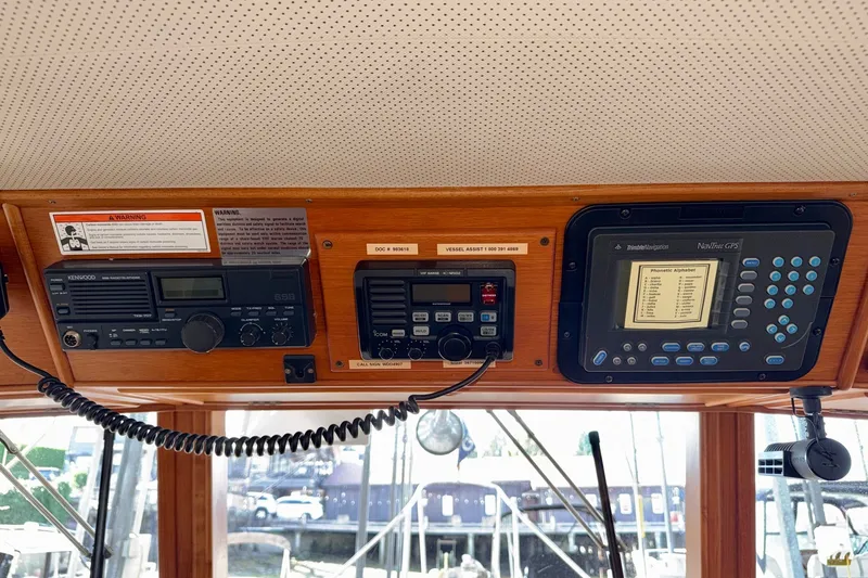 Slide: The Image of Control panel of a 1988 Grand Banks 42 Classic boat with navigation and communication equipment. - 33