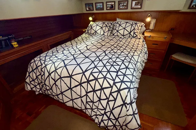 Slide: The Image of Cozy bedroom in 1988 Grand Banks 42 Classic yacht with geometric bedding and wooden furnishings. - 57