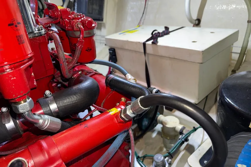 Slide: The Image of Engine room of 1988 Grand Banks 42 Classic with red mechanical components. - 83