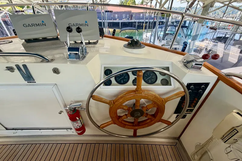 Slide: The Image of Helm of 1988 Grand Banks 42 Classic with wooden wheel and Garmin navigation. - 26