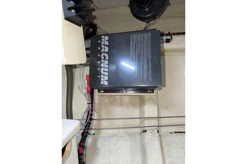 Slide: The Image of Electrical system inside a 1988 Grand Banks 42 Classic boat, featuring a Magnum Energy inverter. - 77