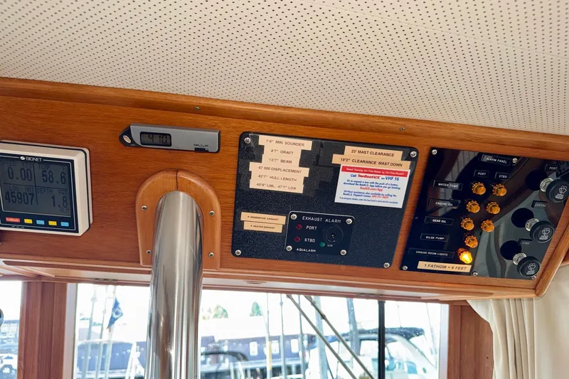 Slide: The Image of Control panel of a 1988 Grand Banks 42 Classic yacht with various gauges and alarms. - 34