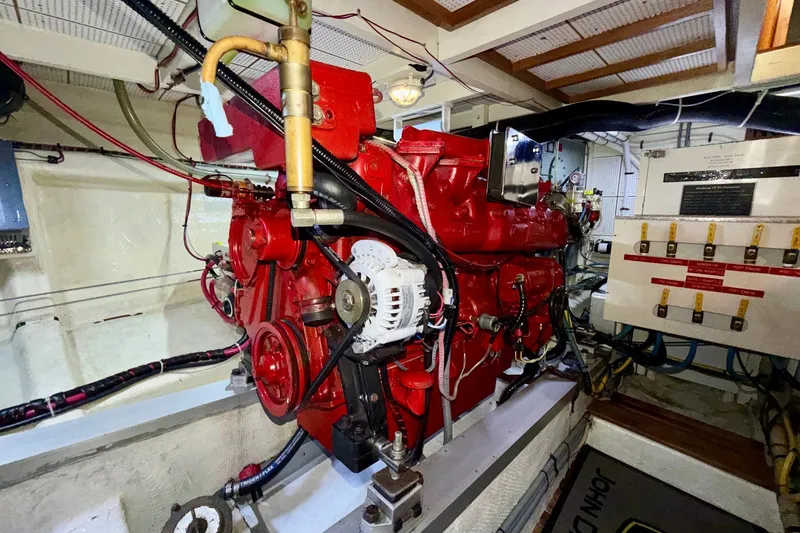 Slide: The Image of Engine room of a 1988 Grand Banks 42 Classic yacht, featuring a red engine. - 72