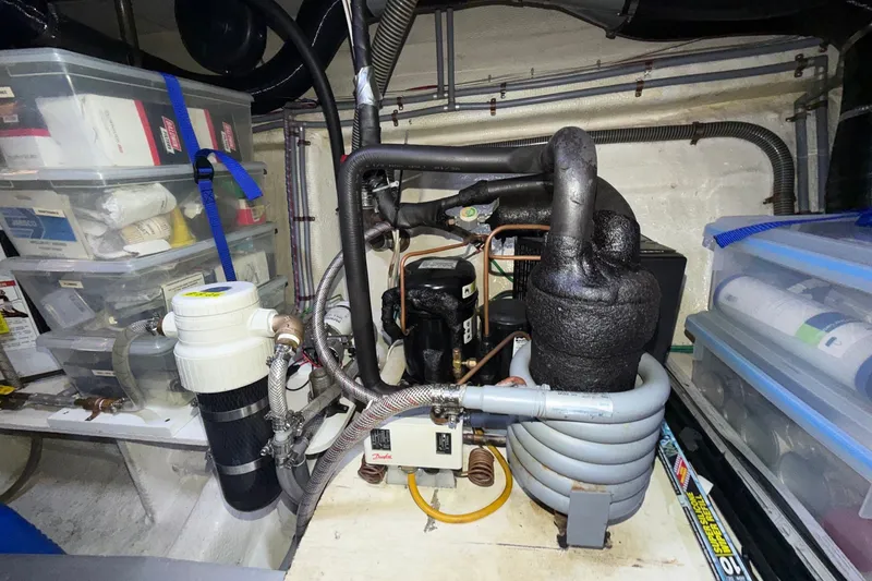 Slide: The Image of Engine room of a 1988 Grand Banks 42 Classic with organized storage and mechanical components. - 70