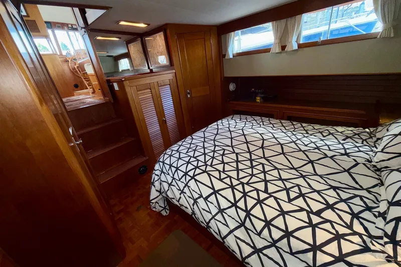 Slide: The Image of Cozy bedroom interior of 1988 Grand Banks 42 Classic yacht with geometric bedding. - 60