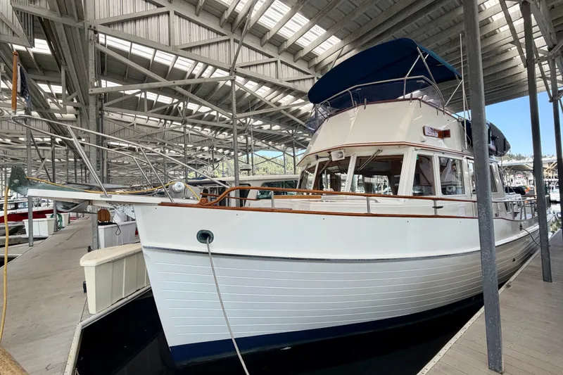 Slide: The Image of 1988 Grand Banks 42 Classic yacht docked in a covered marina. - 14