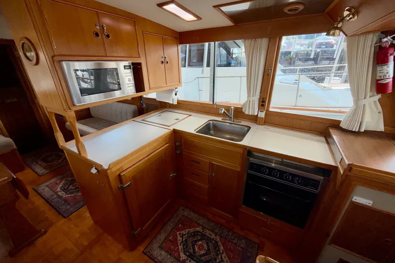 Slide: The Image of Galley kitchen in 1988 Grand Banks 42 Classic yacht with wood cabinetry and modern appliances. - 39