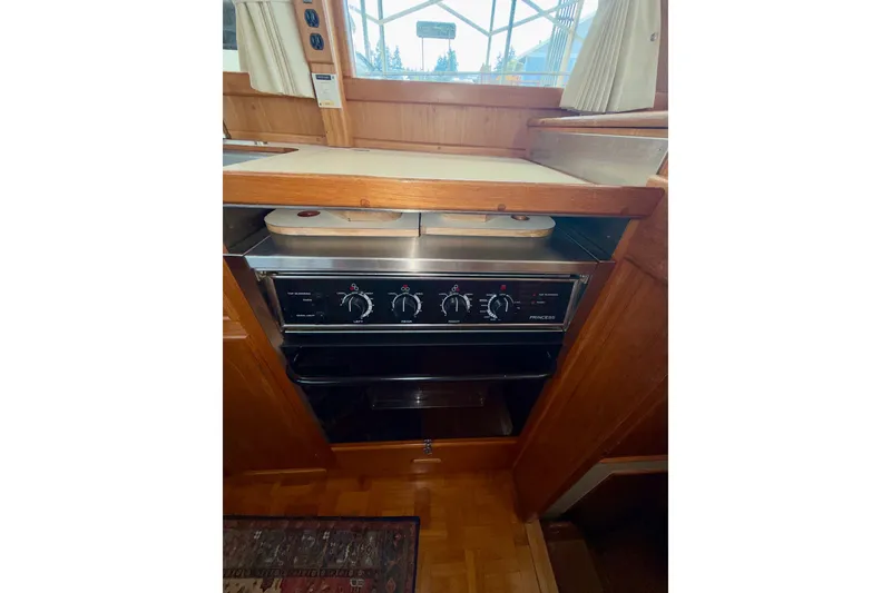 Slide: The Image of Galley kitchen in 1988 Grand Banks 42 Classic yacht with stove and wooden cabinetry. - 45