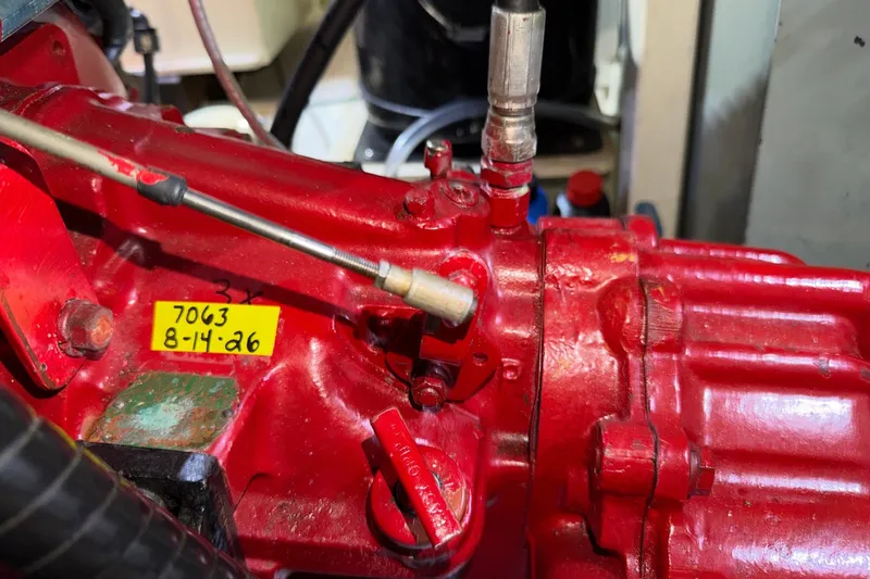Slide: The Image of Close-up of a red engine component in a 1988 Grand Banks 42 Classic boat. - 82