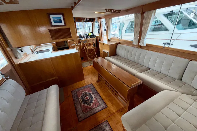 Slide: The Image of Interior of a 1988 Grand Banks 42 Classic yacht with elegant wood finish and plush seating. - 54