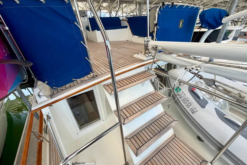 Slide: The Image of Staircase on 1988 Grand Banks 42 Classic yacht with wooden deck and blue covers. - 23