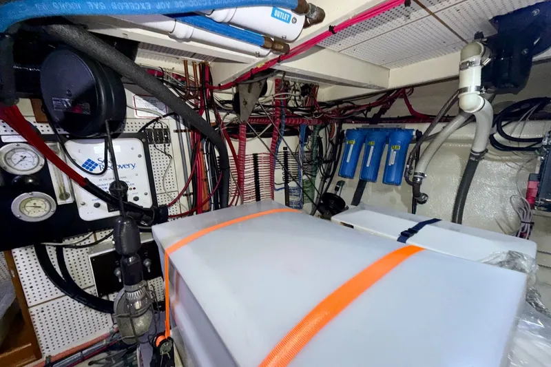 Slide: The Image of Engine room of a 1988 Grand Banks 42 Classic yacht, showcasing equipment and wiring. - 69