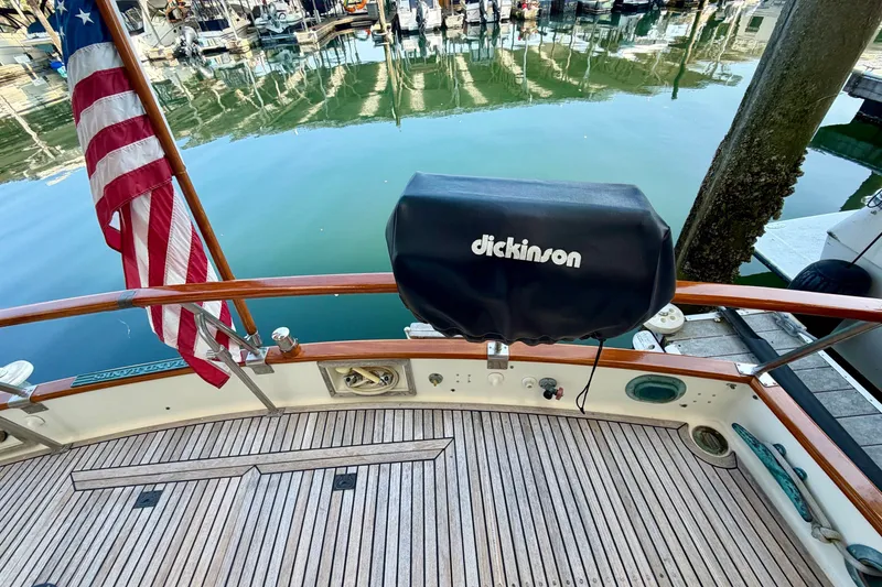 Slide: The Image of Grand Banks 42 Classic 1988 yacht deck with American flag and Dickinson grill. - 21