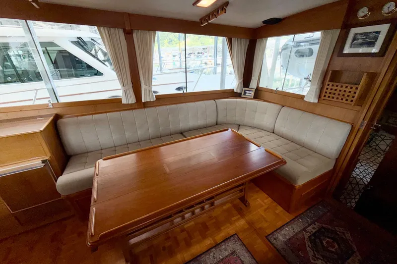 Slide: The Image of Interior of 1988 Grand Banks 42 Classic yacht with cozy seating and wooden table. - 53