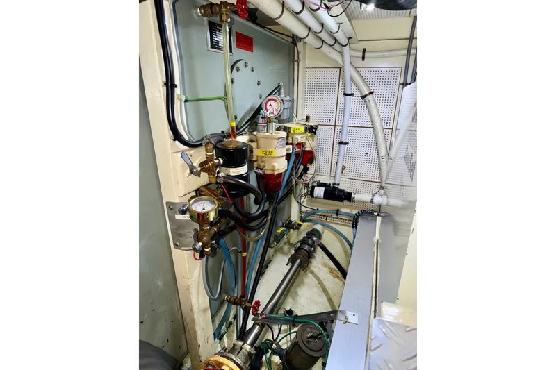 Slide: The Image of Engine room of 1988 Grand Banks 42 Classic yacht, showcasing gauges and piping systems. - 79