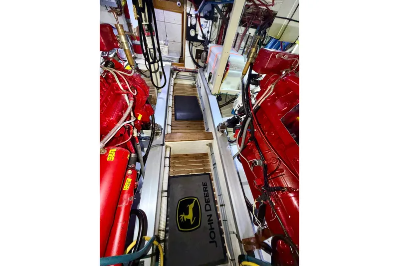 Slide: The Image of Engine room of 1988 Grand Banks 42 Classic with red machinery and John Deere mat. - 67