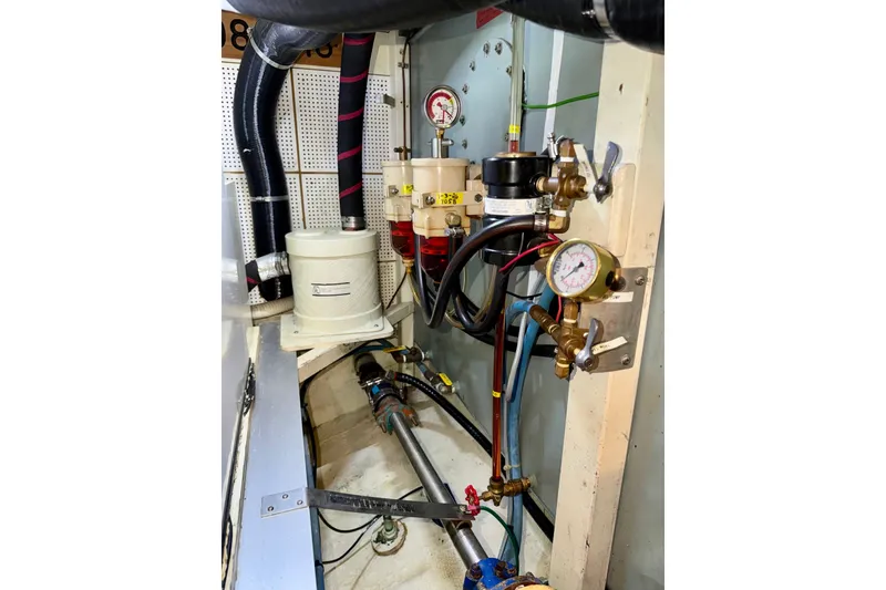 Slide: The Image of Engine room of 1988 Grand Banks 42 Classic, showcasing fuel filtration system and gauges. - 80