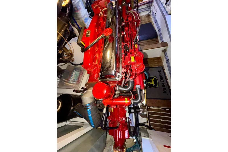Slide: The Image of Engine of a 1988 Grand Banks 42 Classic, featuring vibrant red components. - 65