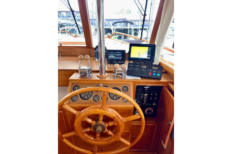 Slide: The Image of Helm of 1988 Grand Banks 42 Classic with wooden wheel and navigation instruments. - 32