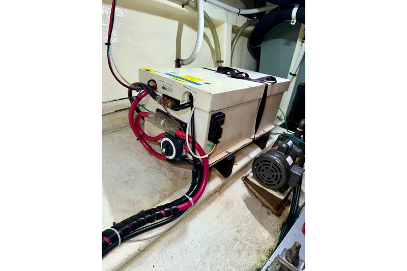 Slide: The Image of Engine room of 1988 Grand Banks 42 Classic with electrical components and wiring. - 76