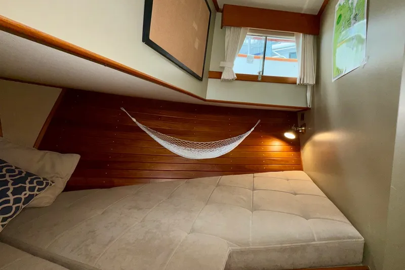 Slide: The Image of Cozy cabin interior of 1988 Grand Banks 42 Classic yacht with hammock and window. - 48