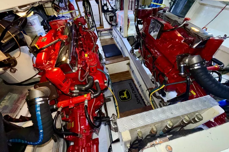 Slide: The Image of Engine room of a 1988 Grand Banks 42 Classic with red machinery and John Deere mat. - 64