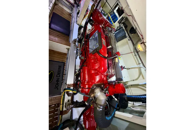 Slide: The Image of Engine room of a 1988 Grand Banks 42 Classic yacht with a red engine. - 66