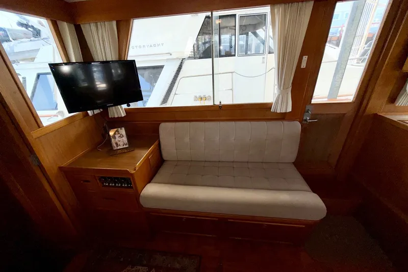 Slide: The Image of Interior of 1988 Grand Banks 42 Classic yacht with sofa, TV, and window view. - 55