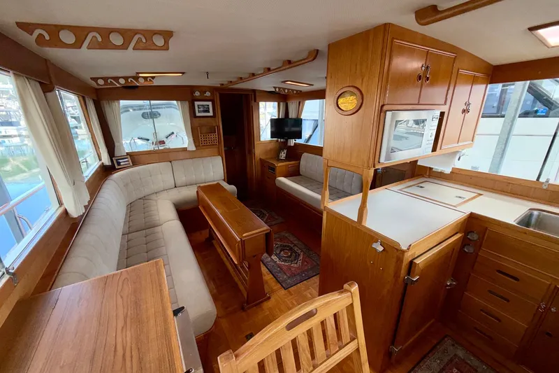 Slide: The Image of Interior of a 1988 Grand Banks 42 Classic yacht with wood finishes and cozy seating. - 40