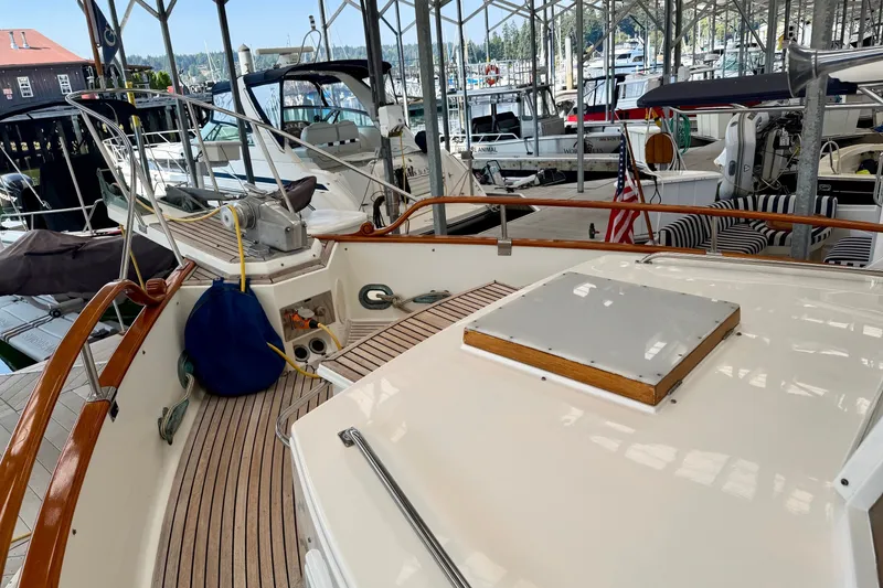 Slide: The Image of 1988 Grand Banks 42 Classic yacht docked in a marina, showcasing its elegant deck design. - 30