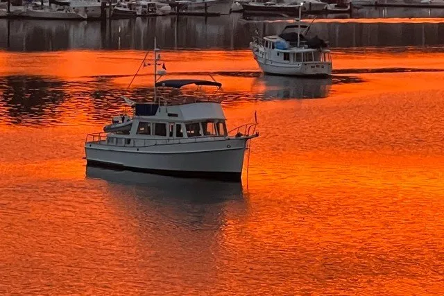 Slide: The Image of Grand Banks 42 Classic yacht on vibrant orange sunset waters, 1988 model. - 85