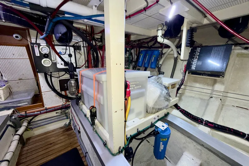 Slide: The Image of Engine room of a 1988 Grand Banks 42 Classic, showcasing wiring and equipment. - 68
