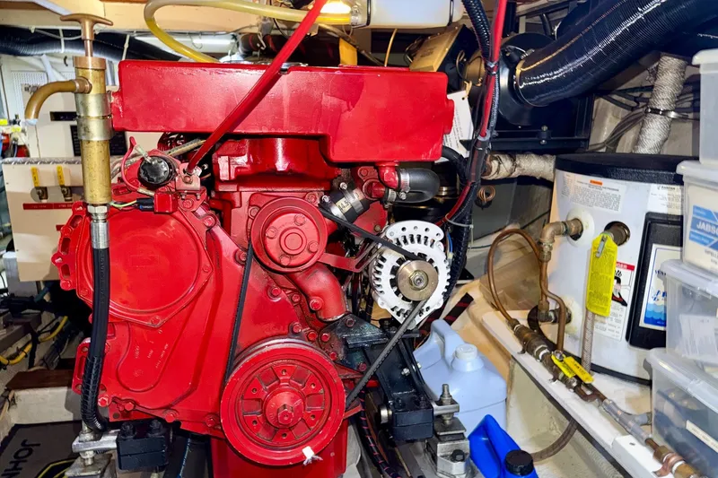 Slide: The Image of Engine room of a 1988 Grand Banks 42 Classic, featuring a red marine engine. - 74