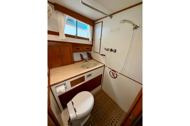 Slide: The Image of Bathroom interior of 1988 Grand Banks 42 Classic yacht, featuring sink, shower, and toilet. - 49