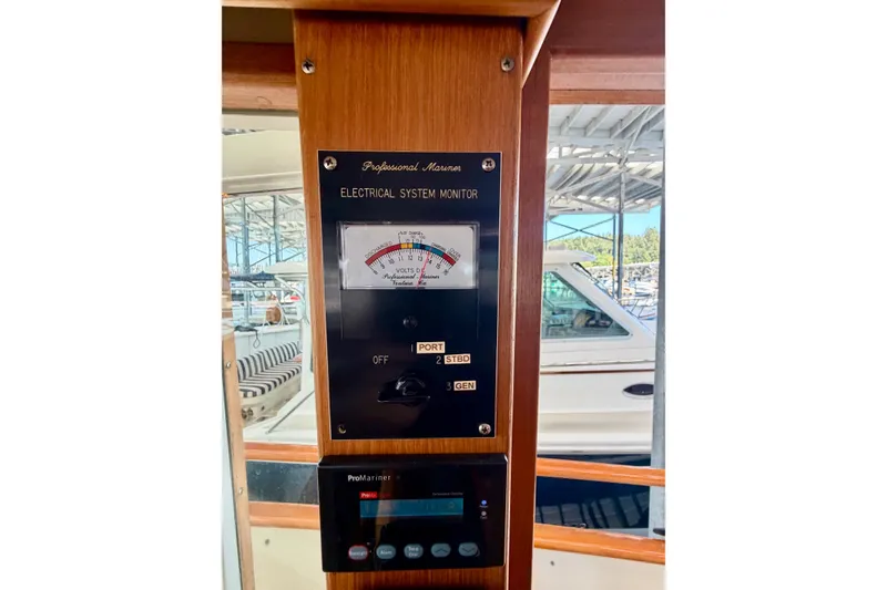 Slide: The Image of Electrical system monitor on 1988 Grand Banks 42 Classic yacht, docked with boats visible outside. - 31