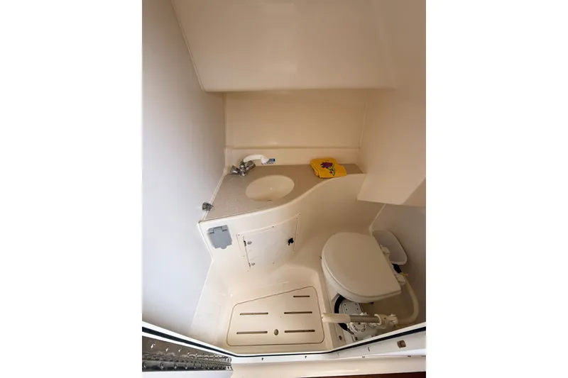 Slide: The Image of 1999 Pursuit 2860 Denali boat bathroom with sink and toilet. - 18
